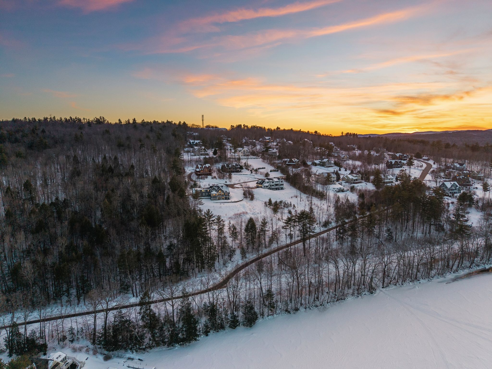 Outdoor patio with a built-in hot tub, patio furniture, an American flag, and a backyard surrounded by trees