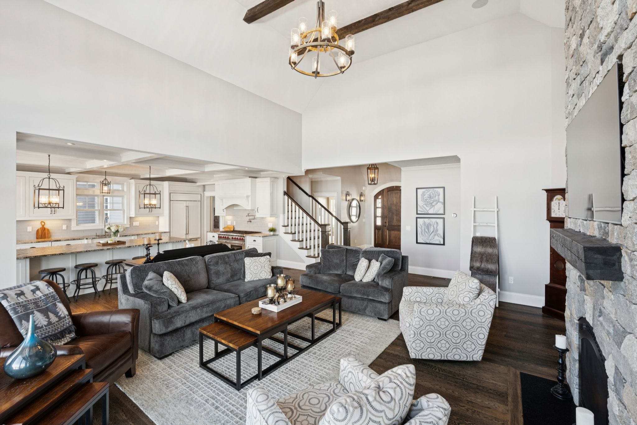 Interior entryway with hat racks, baskets, wooden cabinets, and a painting on the wall