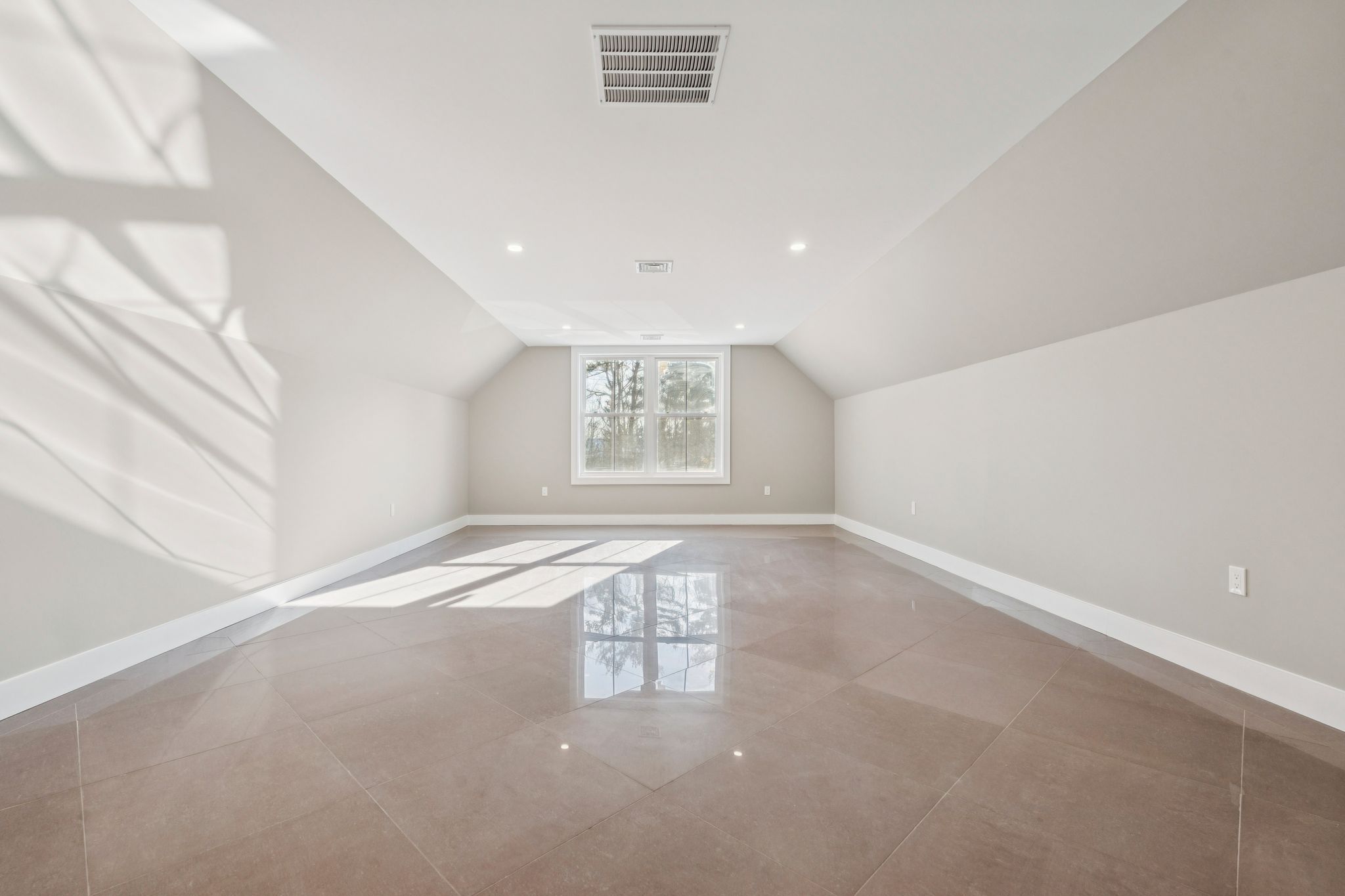 Walk-in closet with clothing, shoes, and storage shelves featuring various garments and accessories