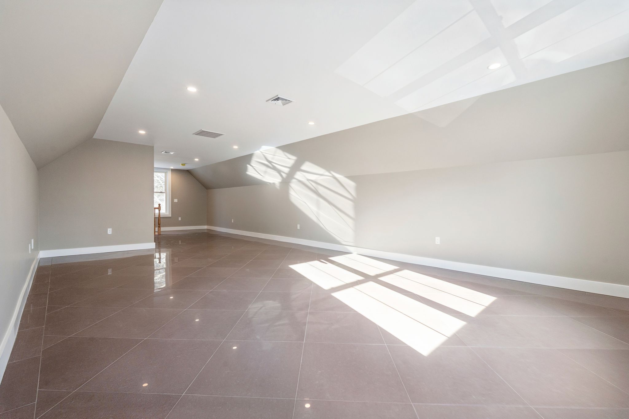Indoor recreational room with a pool table overlooking a snowy outdoor landscape through large windows