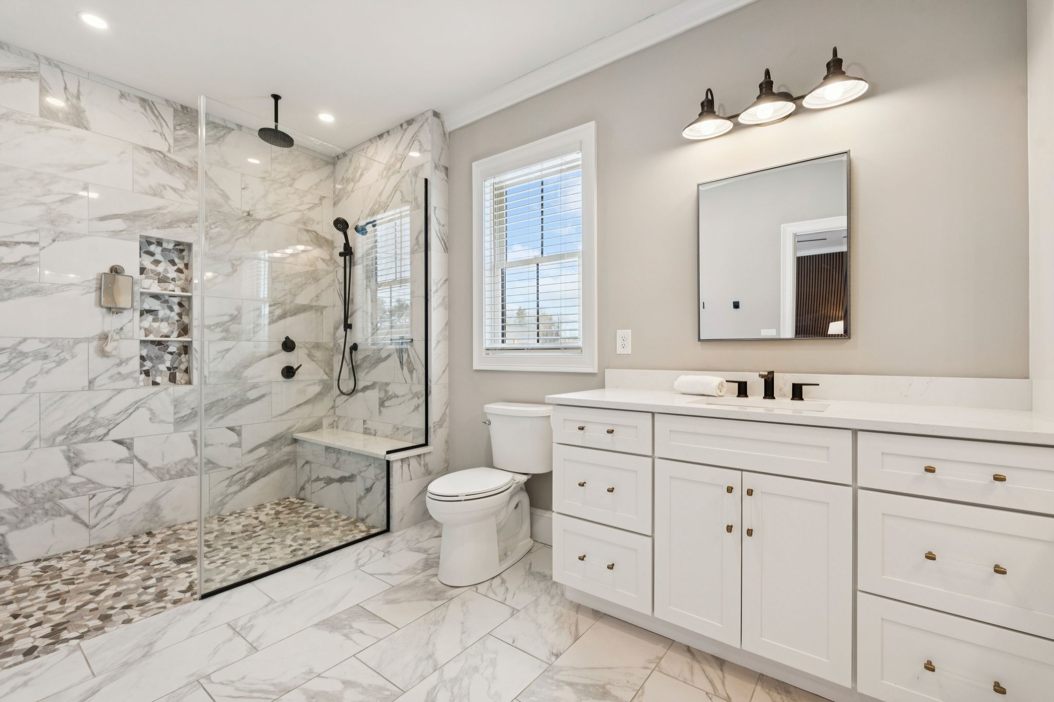 Snow-covered backyard with leafless trees and a clear blue sky during winter day