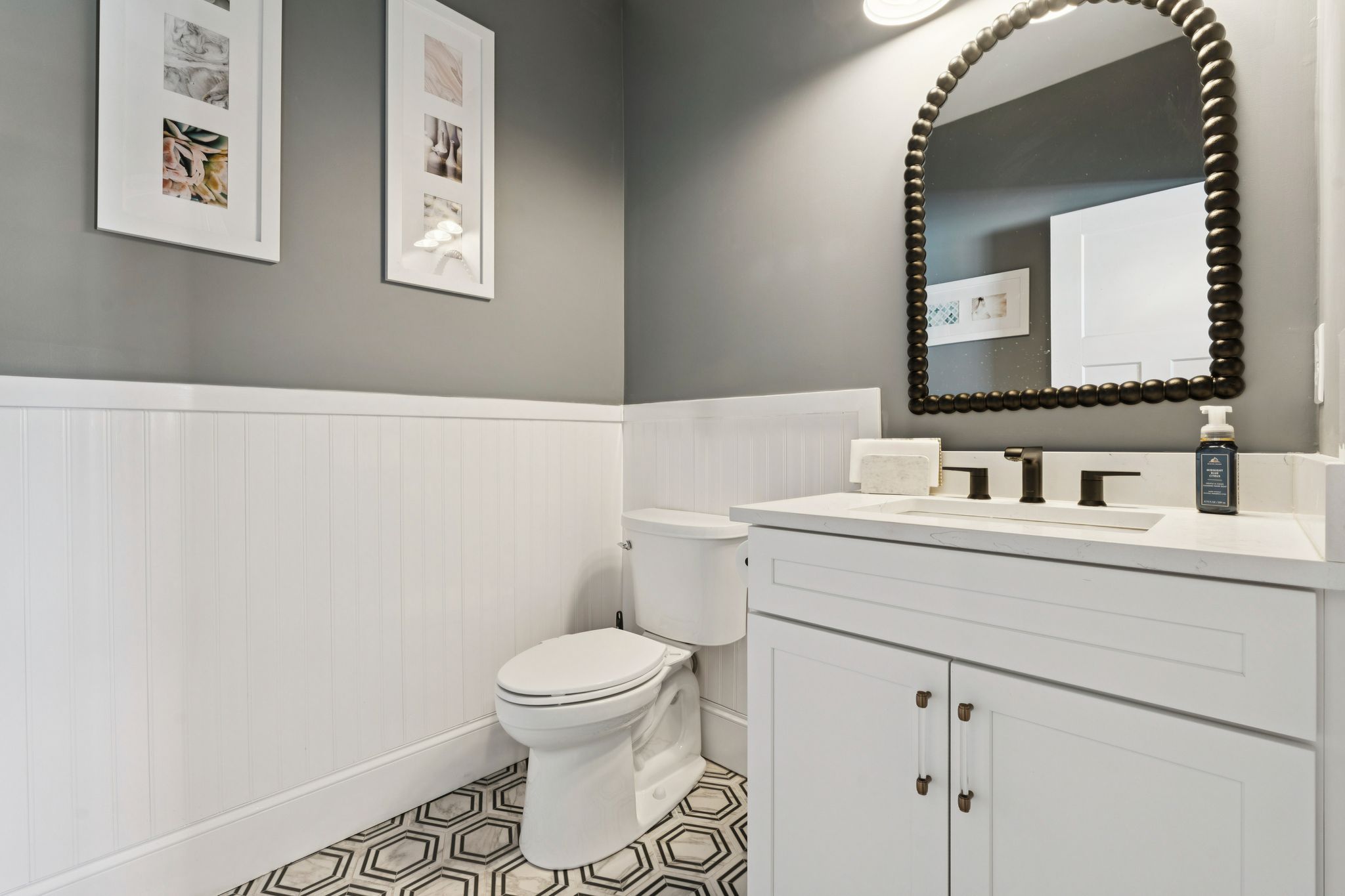 Snow-covered backyard with leafless trees and a clear blue sky during winter day