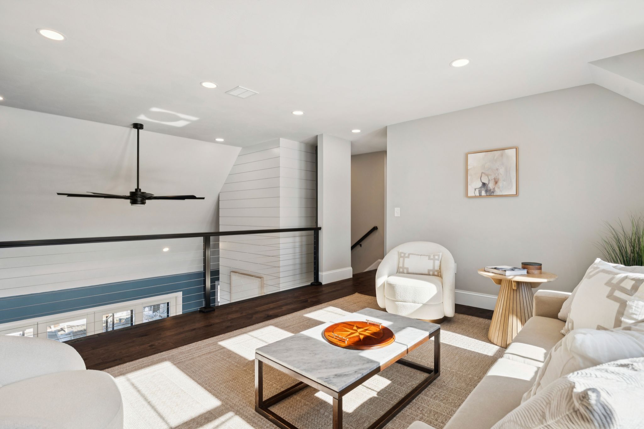 Snow-covered backyard with leafless trees and a clear blue sky during winter day