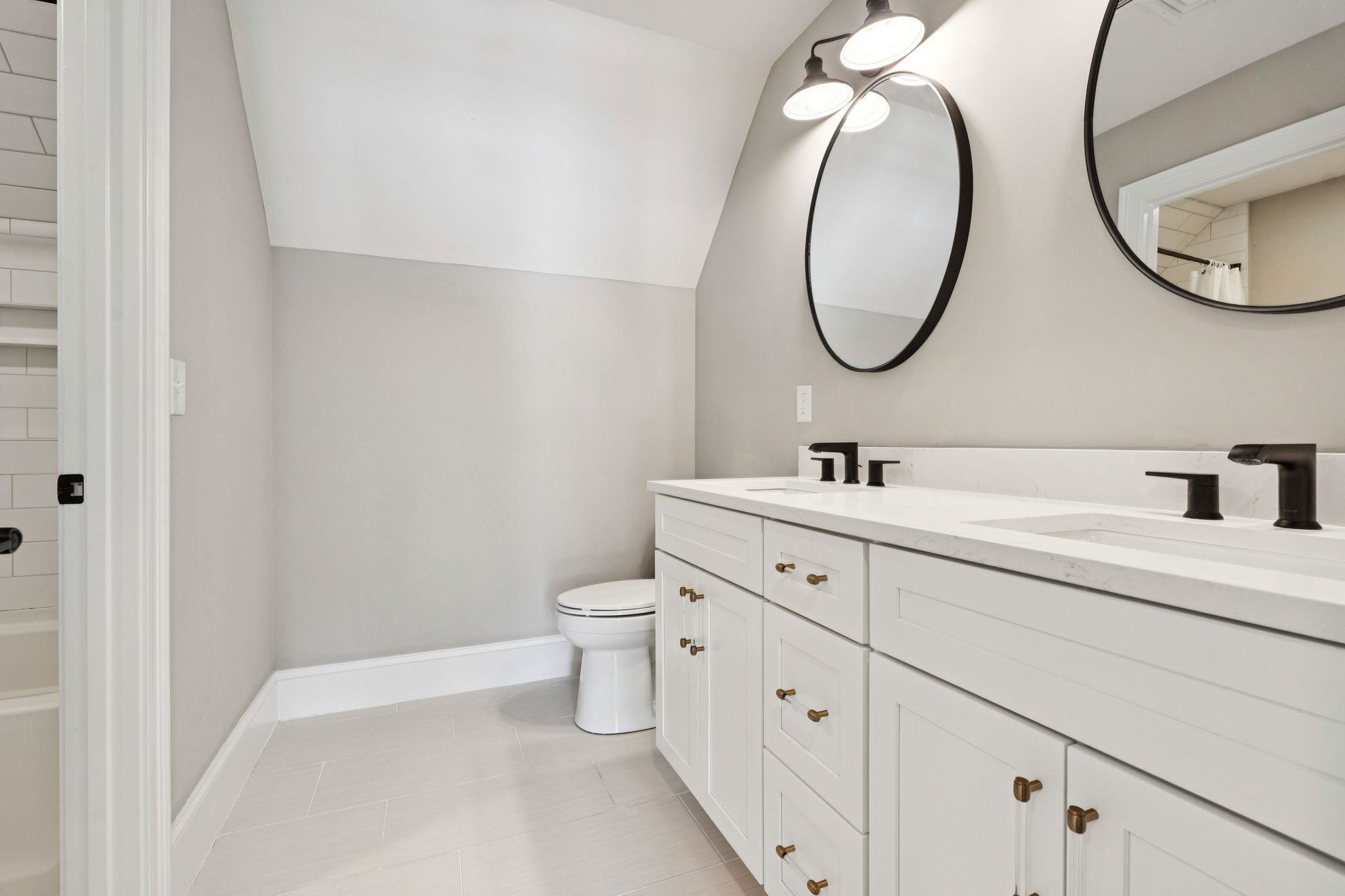 Snow-covered backyard with leafless trees and a clear blue sky during winter day