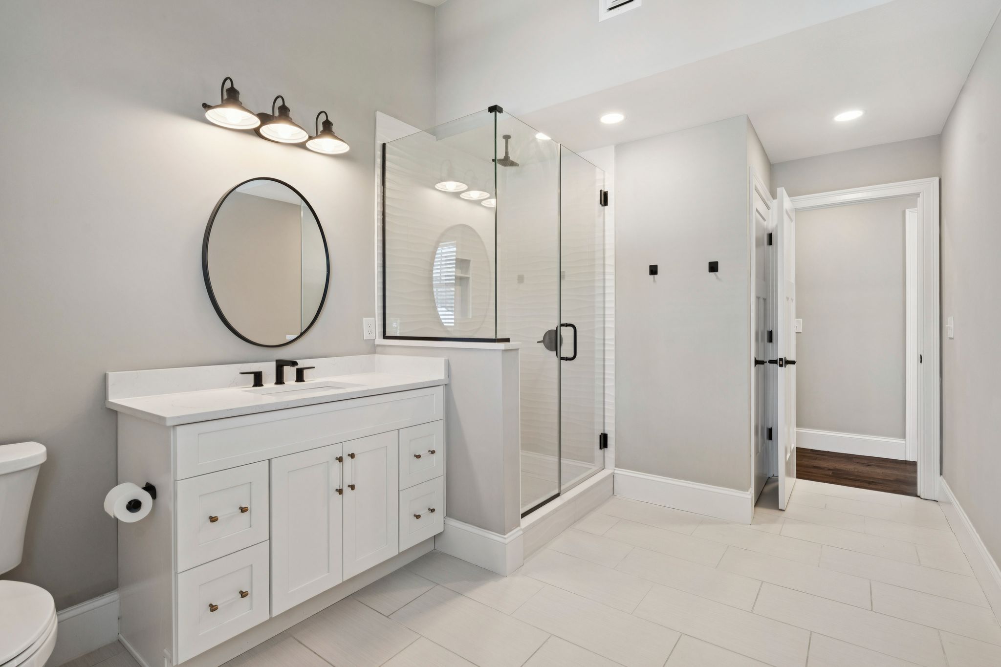 Snow-covered backyard with leafless trees and a clear blue sky during winter day