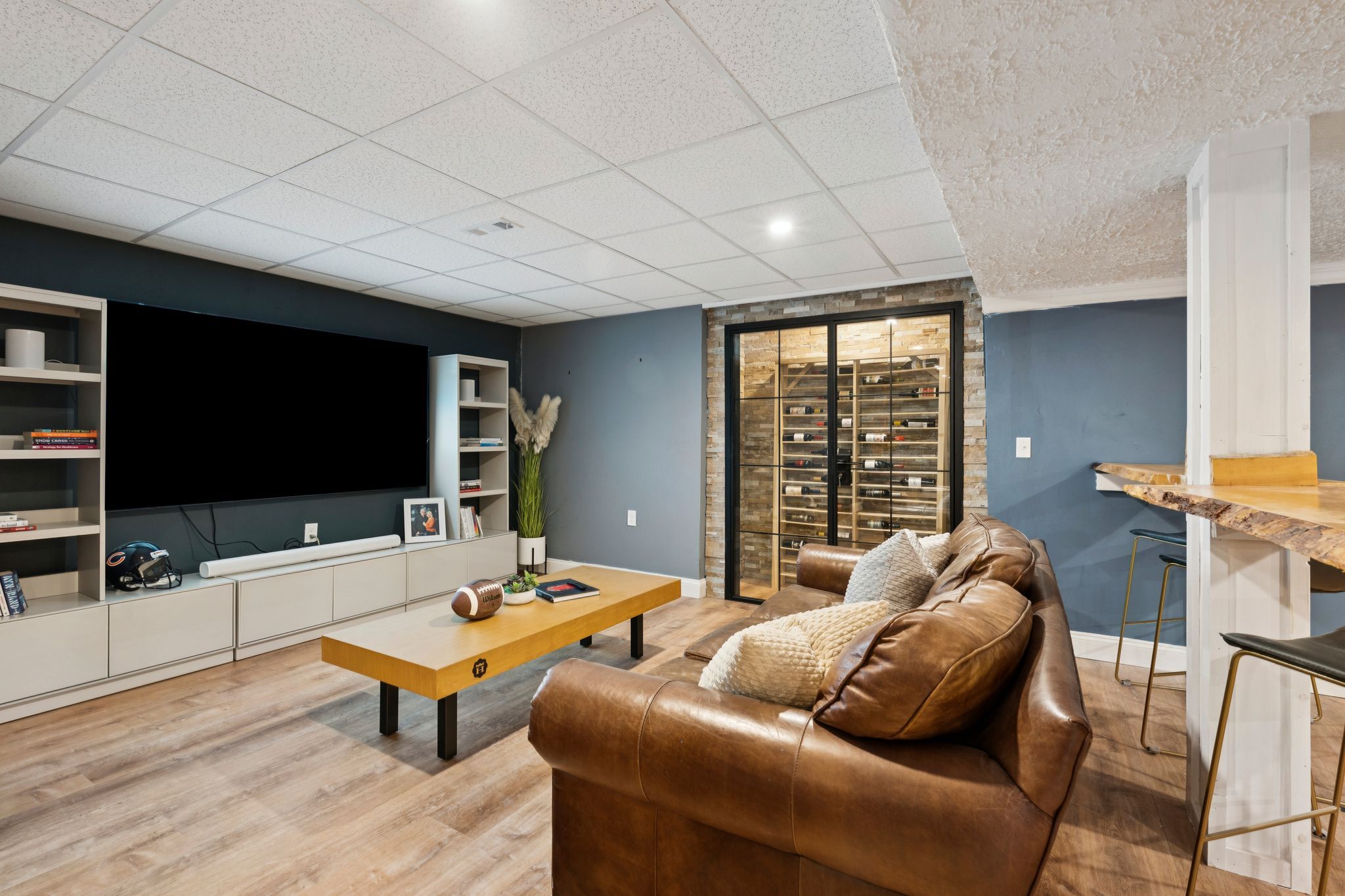 Snow-covered backyard with leafless trees and a clear blue sky during winter day
