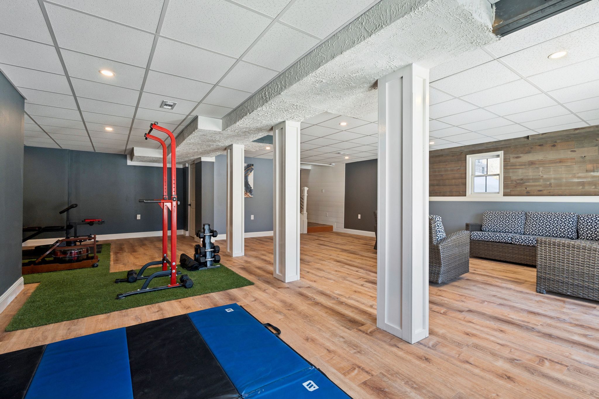 Snow-covered backyard with leafless trees and a clear blue sky during winter day