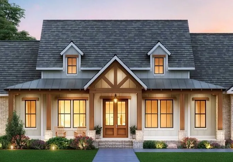 Beautiful modern farmhouse-style home with brick and siding exterior, landscaped front yard, and warm interior lighting at sunset.