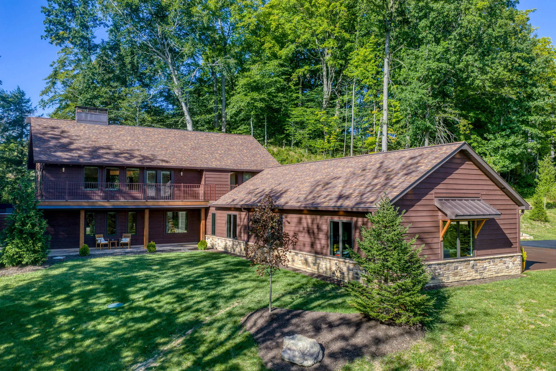 Daytime exterior of 6915 Eagle Rd with attached garage and landscaped grounds