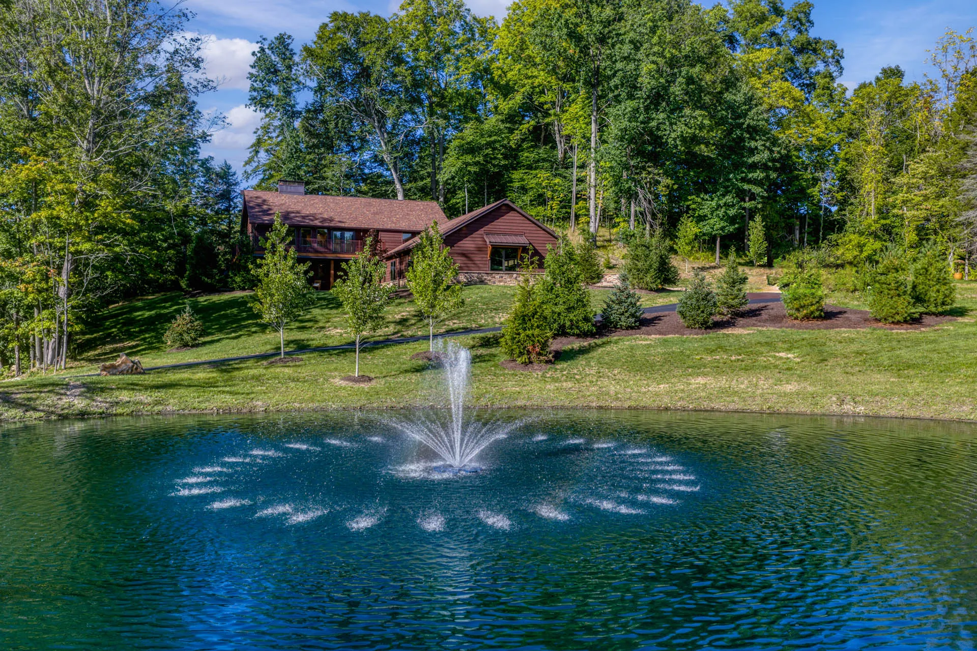 Landscaped grounds with a pond and fountain at 6915 Eagle Rd
