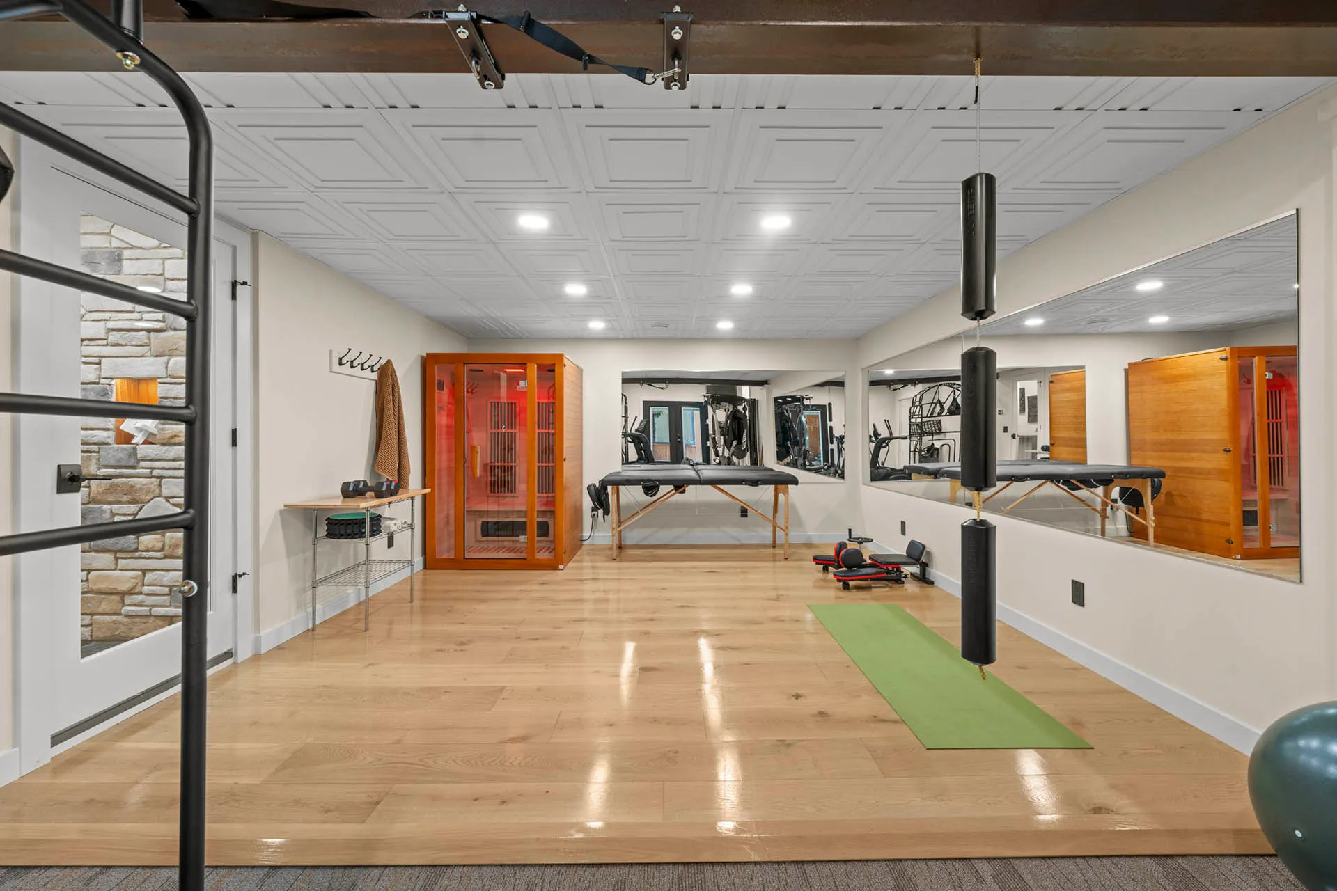 Home gym with exercise equipment and polished wood floors at 6915 Eagle Rd