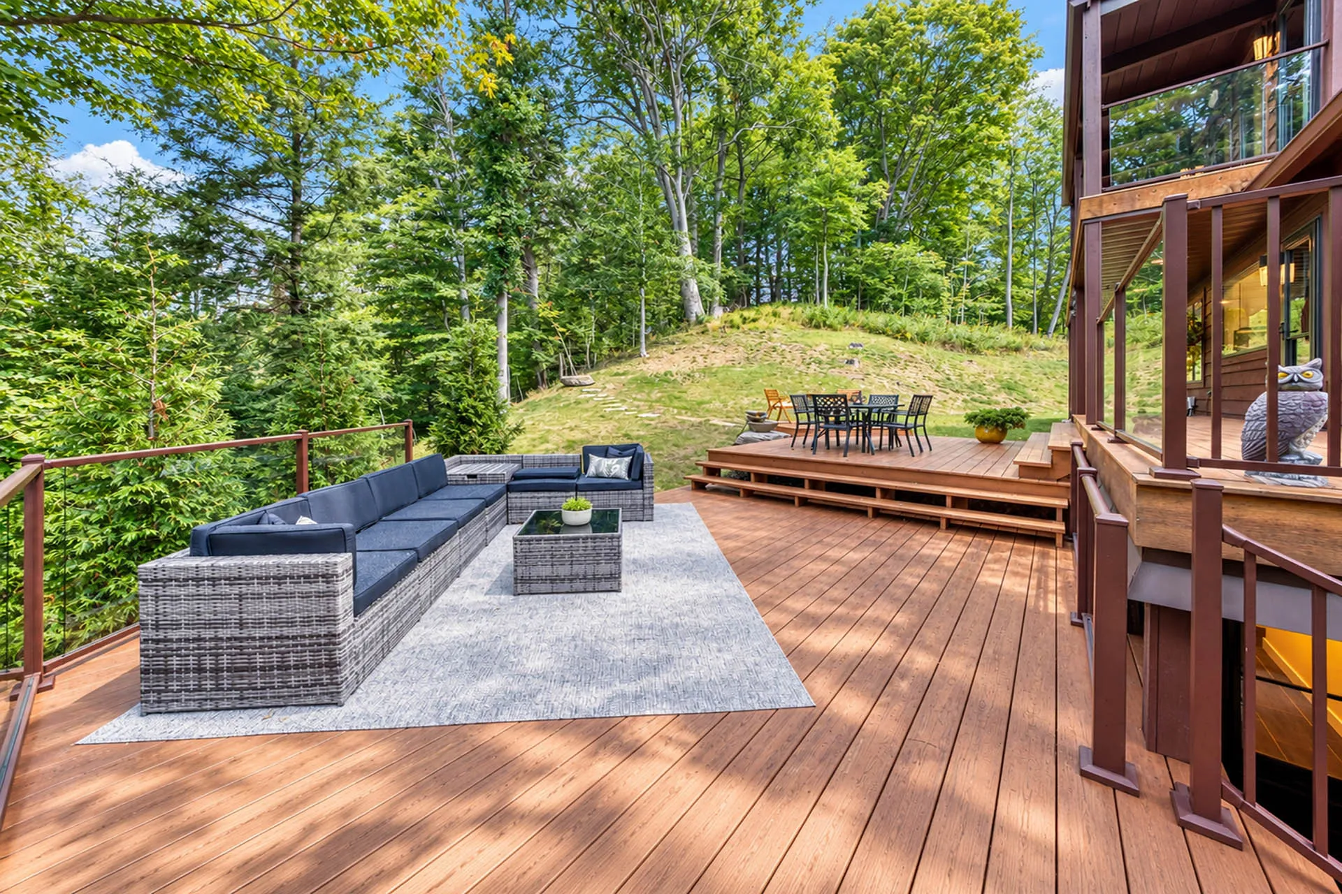 Outdoor deck with lounge seating overlooking a wooded hillside at 6915 Eagle Rd