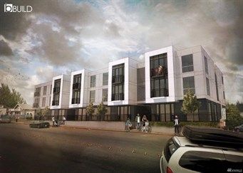 Modern multi-story commercial building with large glass windows and outdoor pedestrian pathway