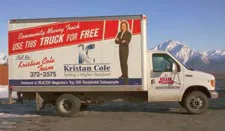 Kristian Cole moving and storage truck offering free use with contact information and promotional message