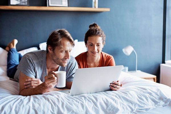 Couple cuddles on couch