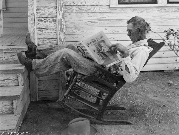 Farmer Reading Farm Paper
