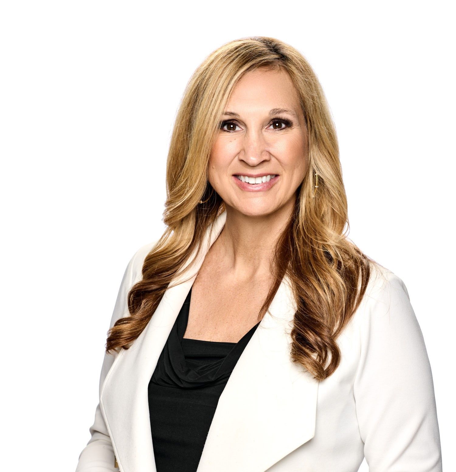 Professional woman with blonde hair smiling, wearing a black top and white blazer, against a white background.