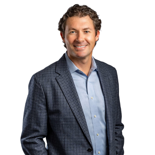 Portrait of a smiling middle-aged man in a blue checked blazer and light blue dress shirt on a white background