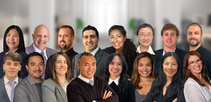 Diverse group of business professionals smiling in an office setting.