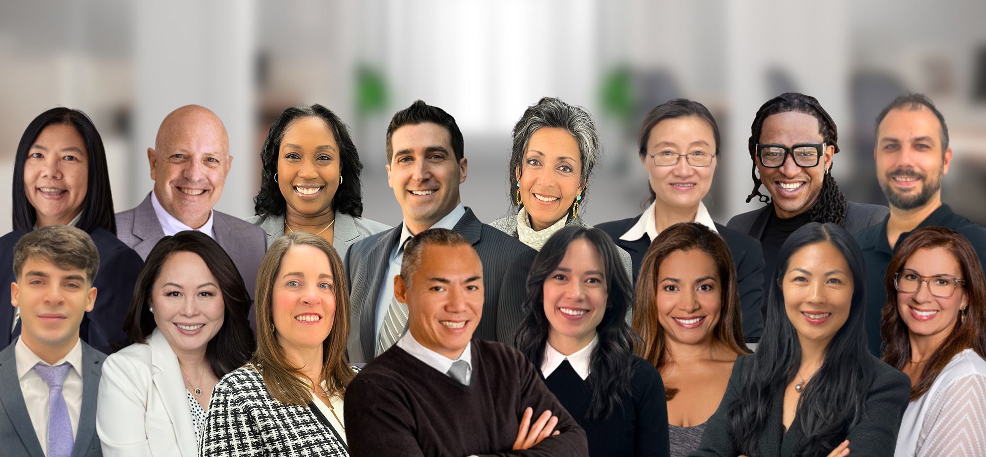 Diverse group of business professionals smiling in an office setting.