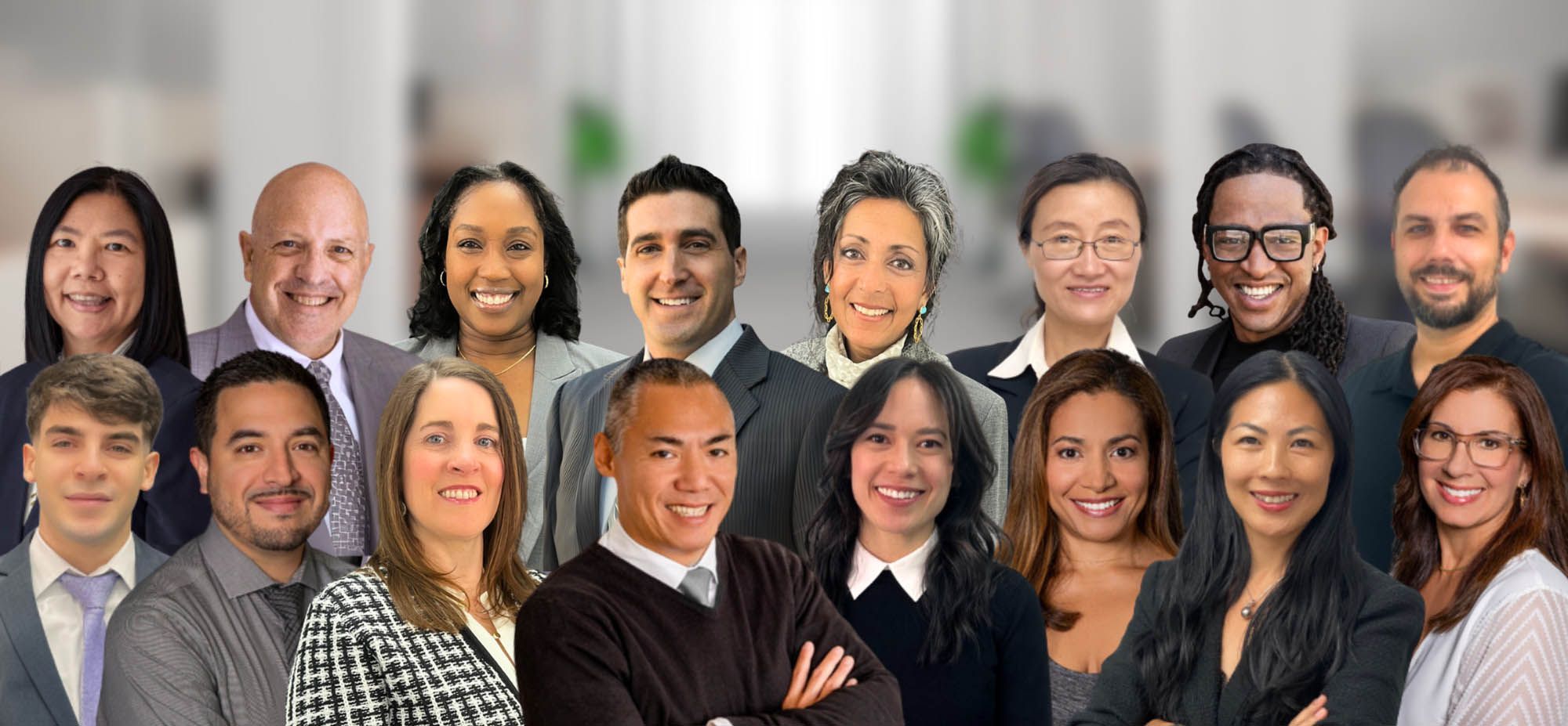 Diverse group of business professionals smiling in an office setting.
