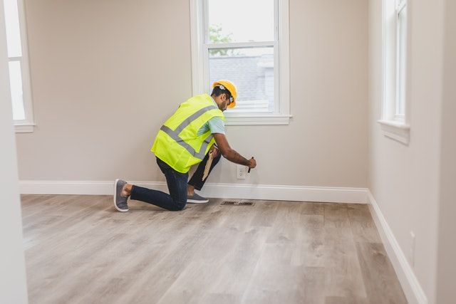 man making repairs inside a house