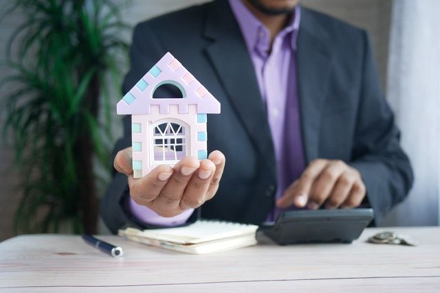 a real estate agent sitting behind a desk