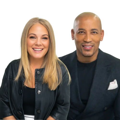 Black and white photo of a diverse man and woman smiling, dressed in professional attire, standing together against a plain background.
