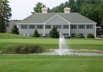 Luxury lakeside house with a front fountain and landscaped lawn on a golf course