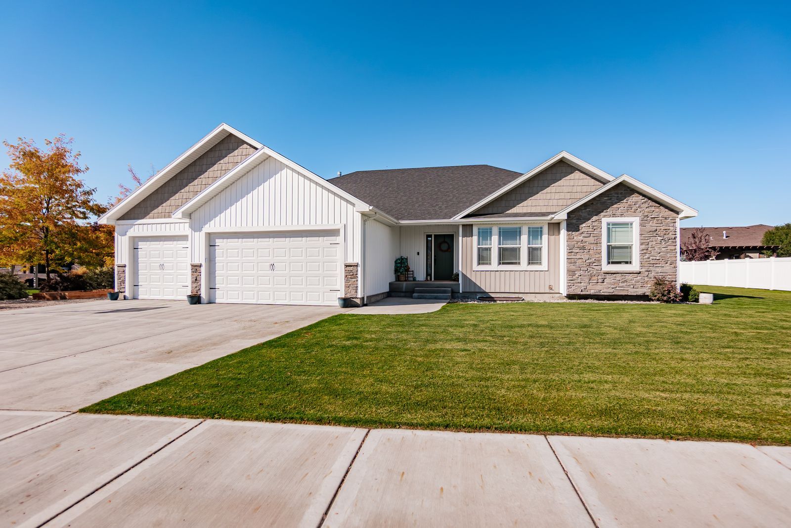 Single-story Vantage Point Homes house with stone accents and a three-car garage in the Idaho Falls area